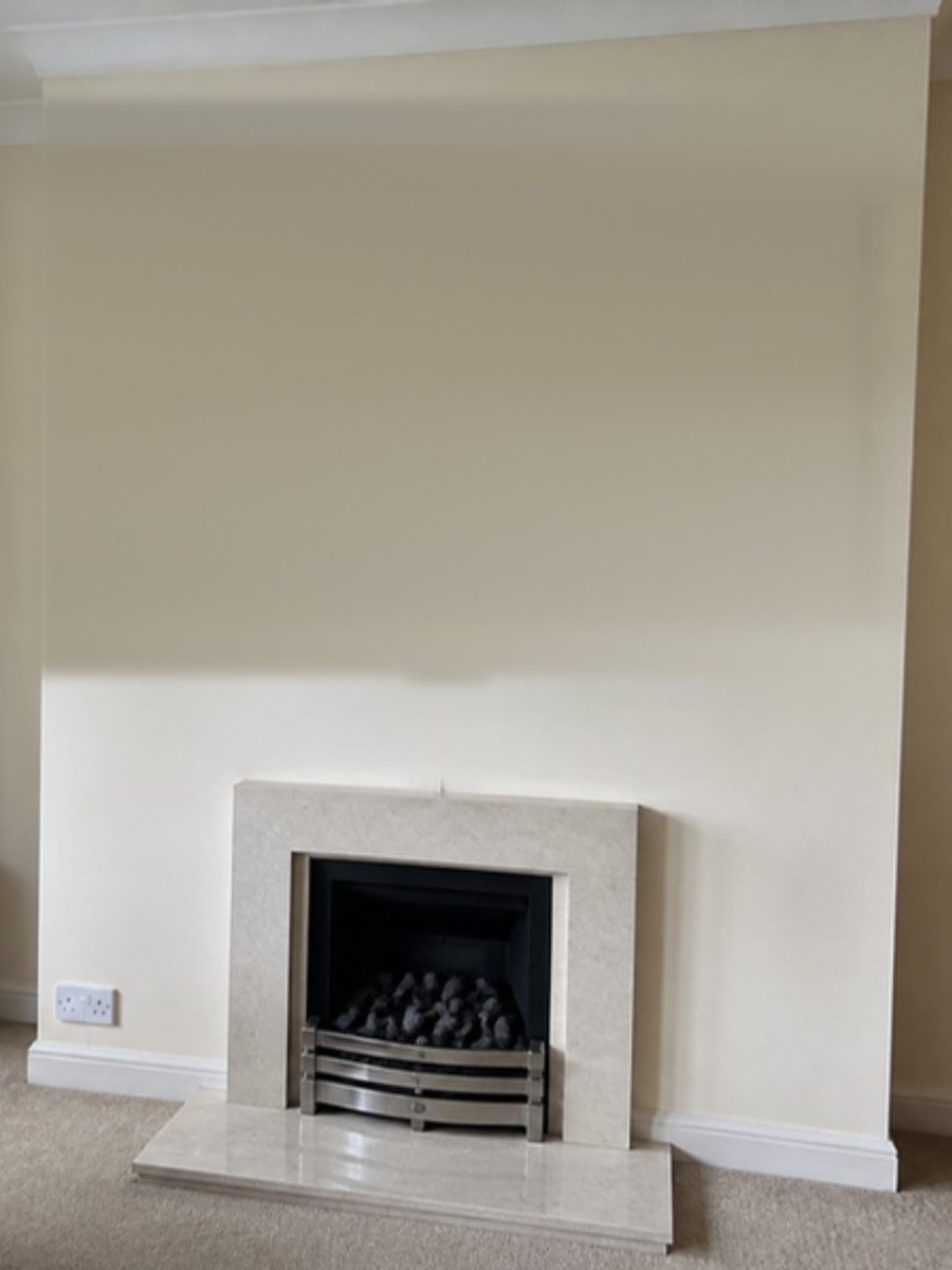 A bare living-room wall photographed on a phone